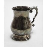 A late Victorian silver tankard of bell shape having flying C-scroll handle on domed foot, maker