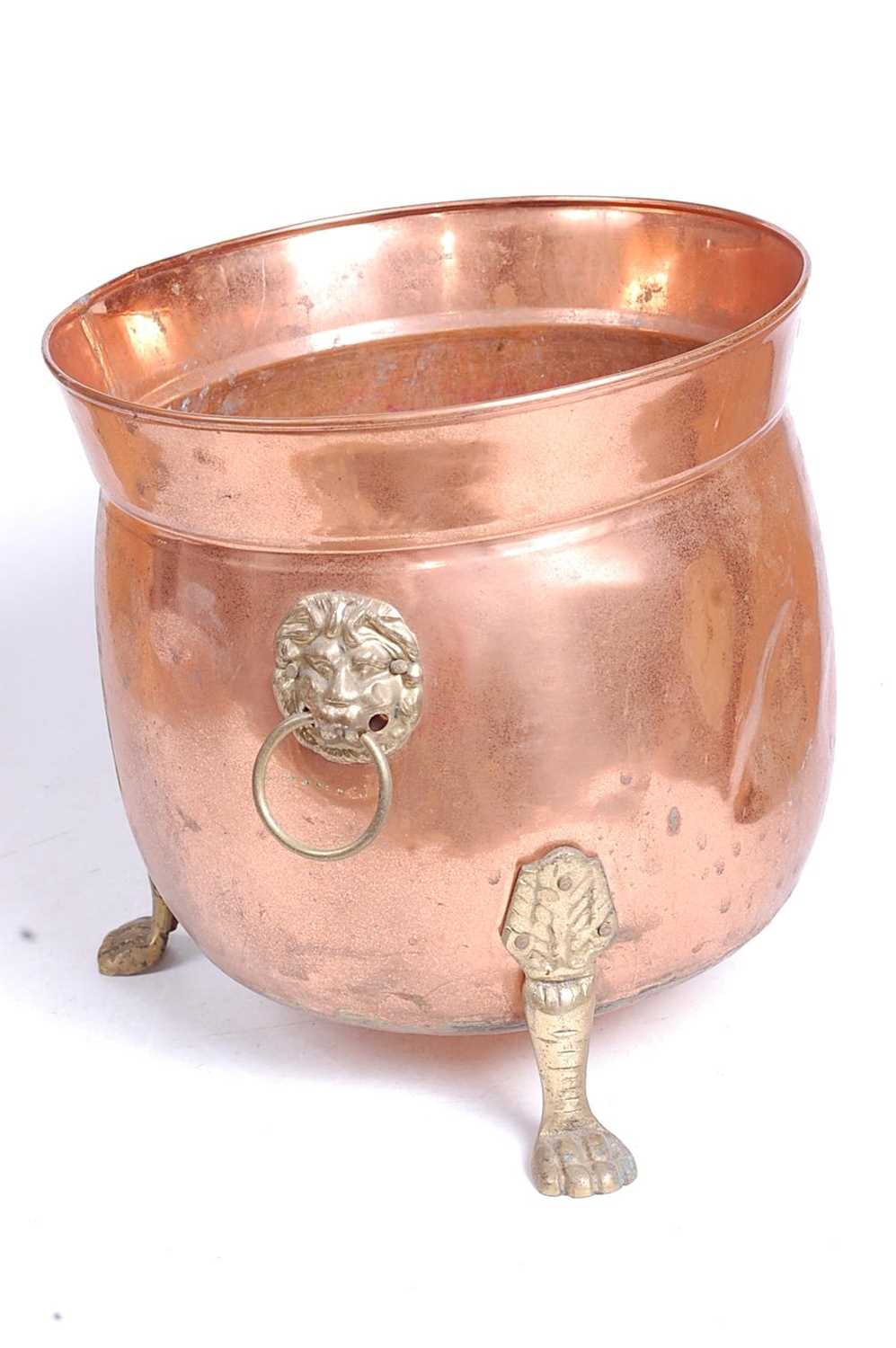 An early 20th century copper and brass jardiniere, flanked by brass lion mask ring handles, standing - Image 2 of 3