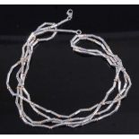 A contemporary white metal sectional long necklace, having yellow metal ball dividers, tests as