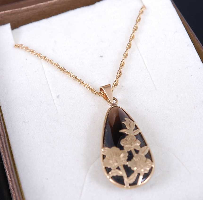 A 9ct gold and black onyx set tear drop pendant on fine link neck chain, pendant height 25mm