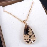 A 9ct gold and black onyx set tear drop pendant on fine link neck chain, pendant height 25mm