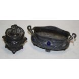 A small Art Nouveau pewter bowl of shaped oval form, having twin handles, inset with blue