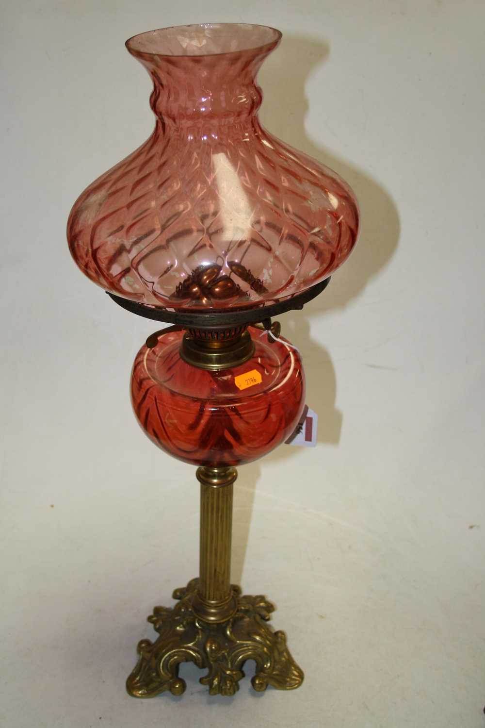 A late 19th century brass and rose-tinted glass oil lamp, h.64cm; together with another similar (2) - Image 2 of 4