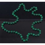 A beaded and knotted green hardstone necklace, 80cm