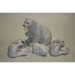 A Royal Copenhagen porcelain model of a seated polar bear with cub, having printed back stamp and