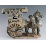 A Chinese green glazed terracotta Mingqi cart, with a single horse flanked by attendants, probably