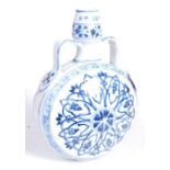 A Chinese export blue and white glazed stoneware moon vase, the neck flanked by twin strap