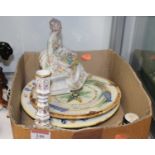 A Luigi Fabris hand painted porcelain model of a lady in seated pose with basket of flowers before