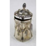An early 20th century continental silver canister of waisted hexagonal form, the hinged dome cover