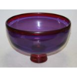 A 20th century purple glass fruit bowl on stand, width 28cm
