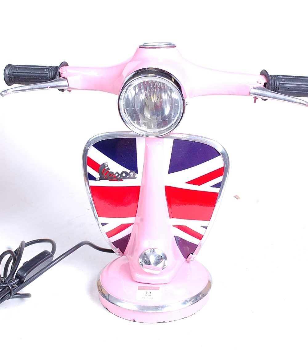 A modern pink painted desk lamp in the form of a Vespa moped, h.33cm