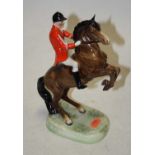 A Beswick figure of a huntsman on rearing horse, model No. 868 in scarlet coat and white breeches,