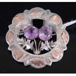 A Scottish silver and amethyst set thistle brooch, with yellow metal overlaid detail, 12.9g, dia.