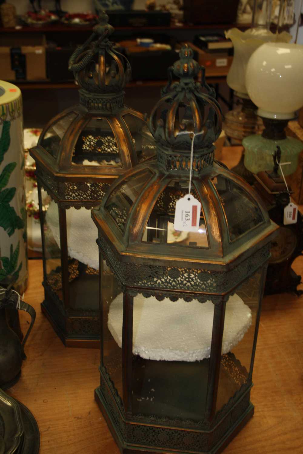 A pair of 20th century copper effect hanging lanterns, the crown finials above an hexagonal body,