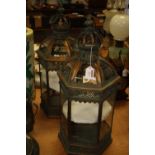 A pair of 20th century copper effect hanging lanterns, the crown finials above an hexagonal body,