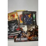A collection of Space Marine Codex books, seven in total, four being paperback editions to include