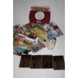 A box of miscellaneous items to include postcards, pin badges, glassware etc