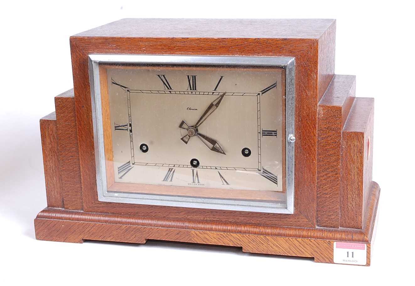 A 1930s Art Deco oak cased mantel clock, of stepped rectilinear form, the eight-day movement with