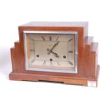 A 1930s Art Deco oak cased mantel clock, of stepped rectilinear form, the eight-day movement with