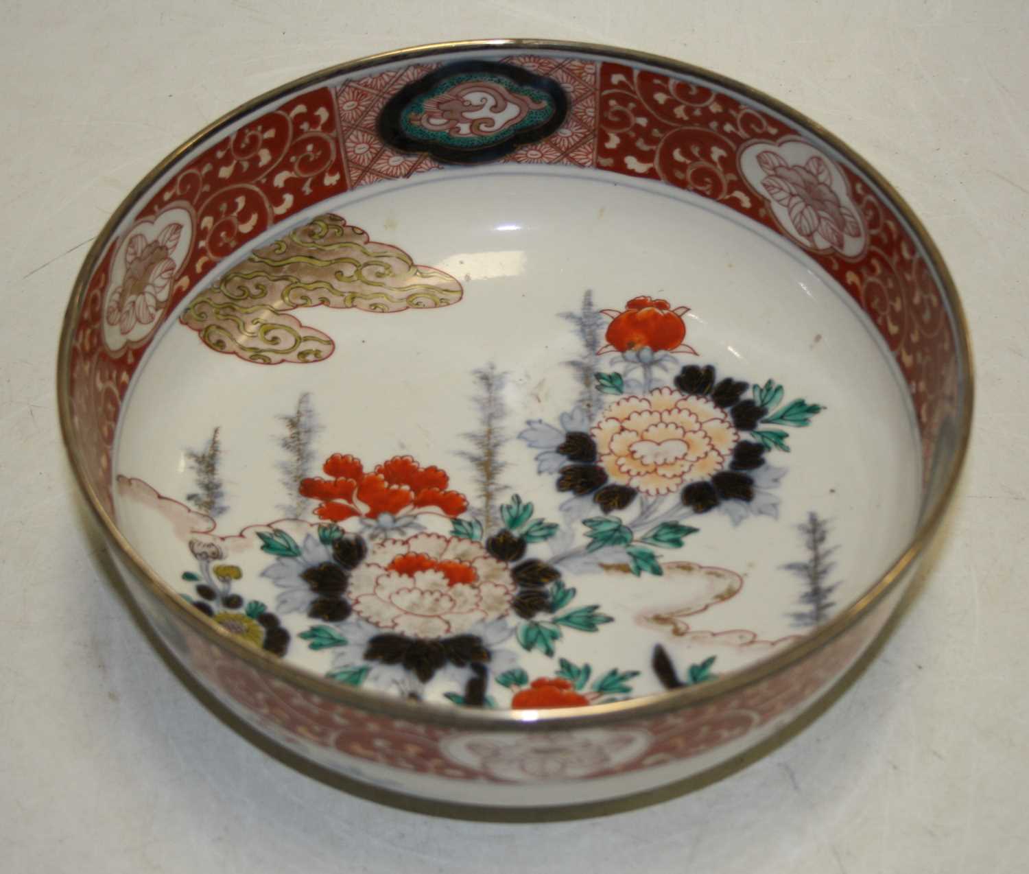 A 19th century bowl, the centre decorated with flowers, in shades of iron red, blue and turquoise,