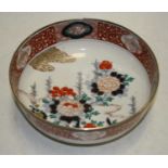 A 19th century bowl, the centre decorated with flowers, in shades of iron red, blue and turquoise,