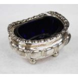 A mid-20th century silver open salt, of fluted rectangular form on ball feet, having blue glass