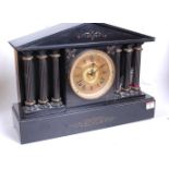 A Victorian black slate mantel clock, of architectural form, the gilt chapter ring showing Roman