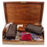 A wooden box containing assorted costume jewellery, enamel pin badges etc