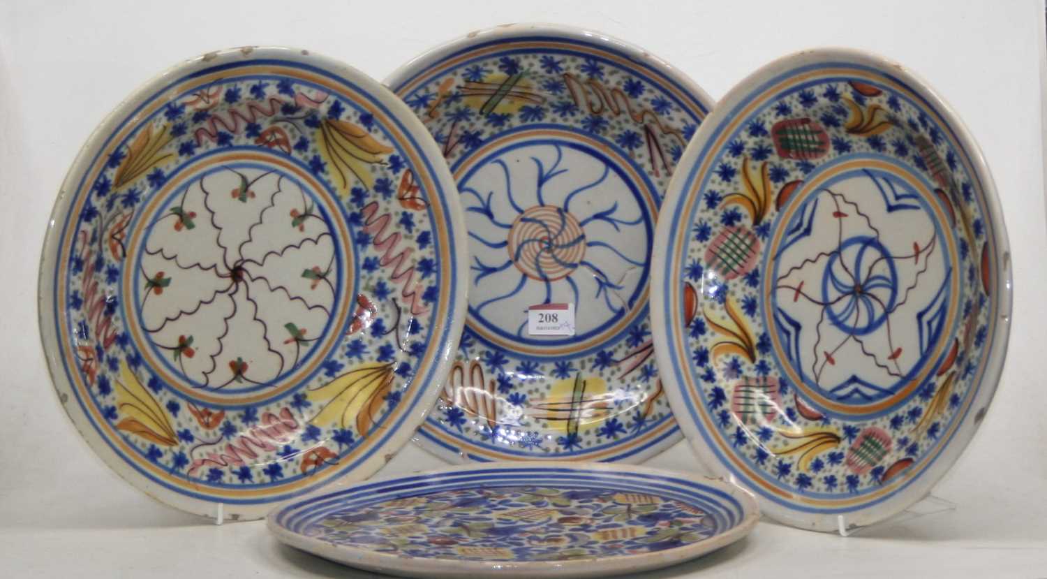 A set of three 20th century continental tin glazed dishes, 31cm dia. together with another similar