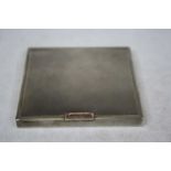 An early 20th century ladies silver powder compact of square shape having all over engine turned