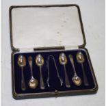 A cased set of six George V silver teaspoons, with sugar tongs in fitted leather case, maker James