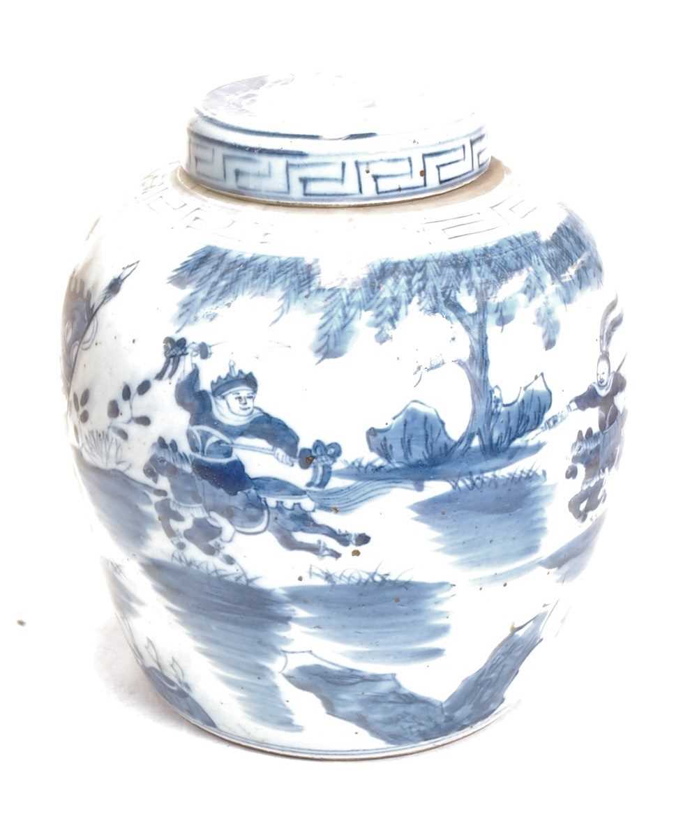 A Chinese export blue and white glazed stoneware ginger jar and cover, decorated with a battle scene