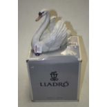 A Lladro Spanish porcelain model of a swan having printed mark verso impressed 5231, 18cm,