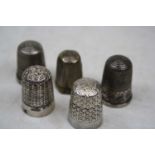 A George V silver thimble by Charles Horner, Chester 1911; together with four other silver
