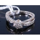 A 9ct white gold diamond circular cluster ring, comprising seven round brilliant cut diamonds,