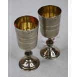 A pair of early 20th century continental white metal Kiddush cups having engine turned decoration