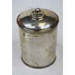 A George V silver canister and cover of cylindrical form, the raised panel relief decorated with