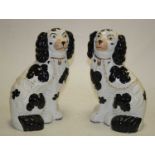 A pair of Staffordshire style flatback models of seated spaniels, h.26cmCondition report: One has