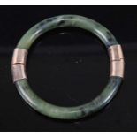 A nephrite gilt metal mounted hinged bangle, 40.7g, dia.8cm