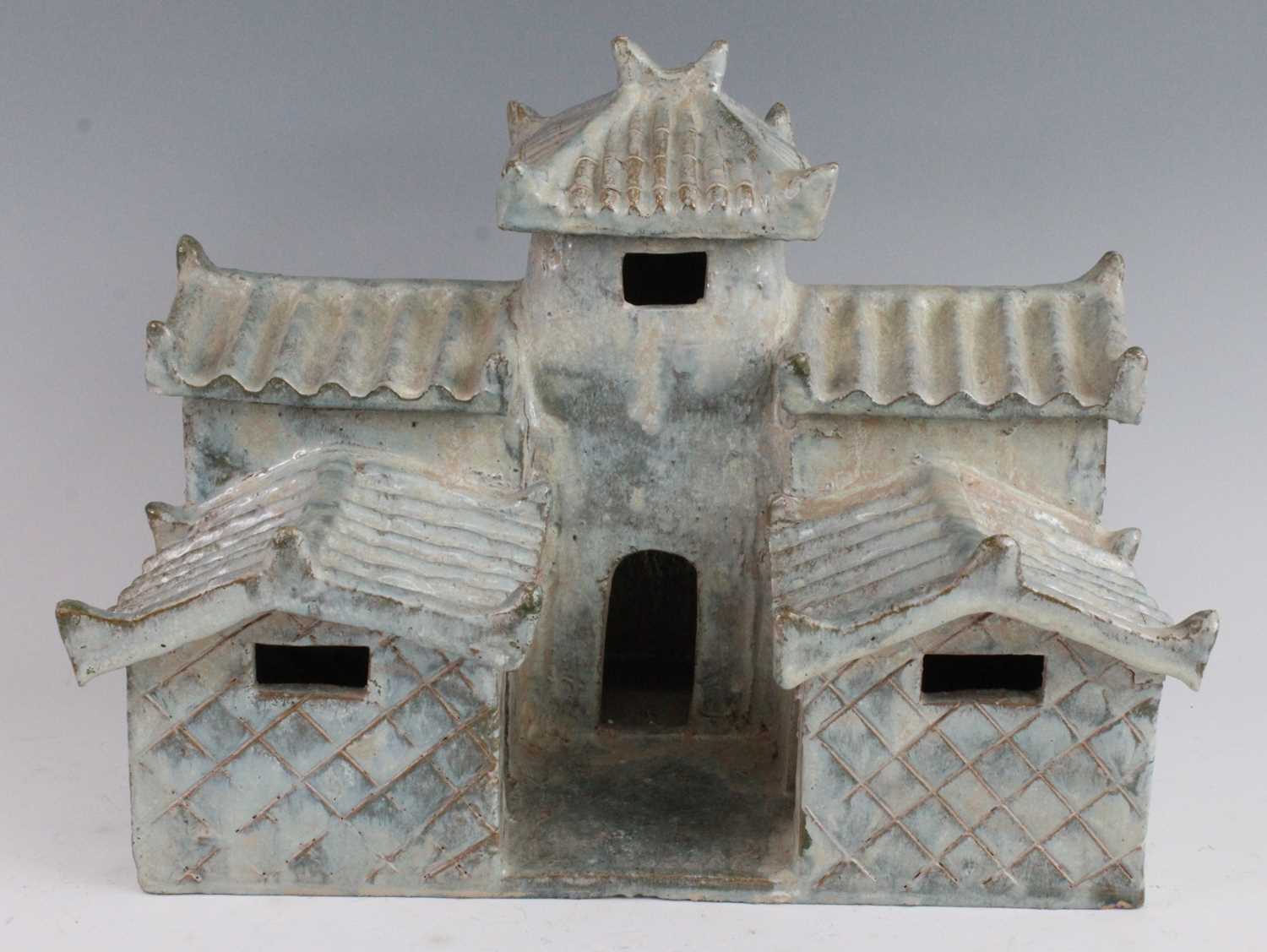 A Chinese green/blue glazed pottery model of a temple, having two tiers each with corrugated style