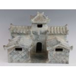 A Chinese green/blue glazed pottery model of a temple, having two tiers each with corrugated style