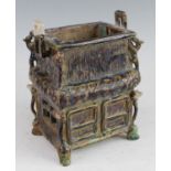 A Chinese sancai glazed pottery incense burner, of rectangular two tiered form, each corner with