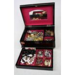 A lacquered jewellery box and contents, to include a faux jet bangle, each link with a topographical