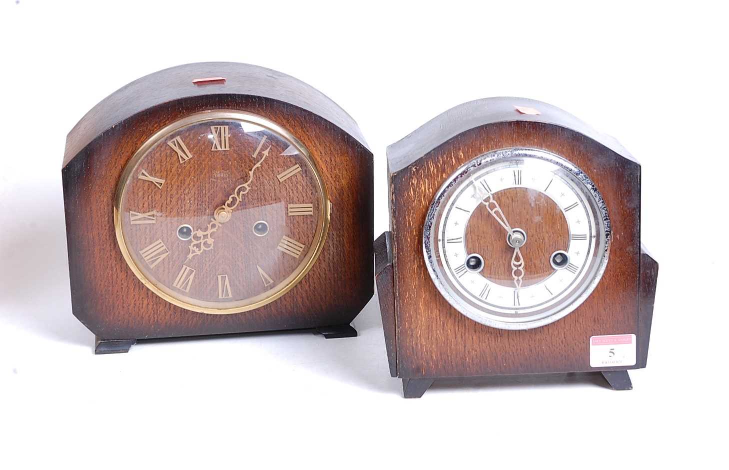 A 1930s oak cased eight-day mantel clock, the chapter ring showing Roman numerals, h.19cm;