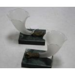 A pair of frosted glass cornucopia vases, each having a shaped bowl with a bronzed metal fist