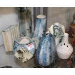 A Carn Pottery vase of slab sided oval form on a blue ground with tubelined decoration, printed Carn