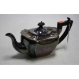 A George V silver teapot of shaped rectangular form having an ebonised finial and handle with