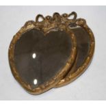 A pair of 20th century gilt framed heart shaped wall mirrors, each surmounted with a bow, 27cm high