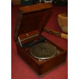 An early 20th century oak cased gramophone; together with a collection of various records