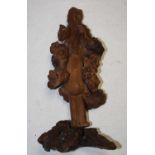 A 20th century Japaneser root-wood figure, carved as a sage in standing pose with fruit in hand h.